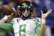 FILE-This Dec. 30, 2013 file photo shows Oregon's Marcus Mariota warms up for the Valero Alamo Bowl NCAA college football game against Texas in San Antonio. All eyes will be on Mariota when the Ducks take the field this season. The junior quarterback could have bolted for the NFL this spring but he decided to stay with the Ducks, who were ranked as high as No. 2 last season before two losses took them out of contention for the national championship. (AP Photo/Eric Gay,File)
