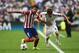 LISBON, PORTUGAL - MAY 24: Raul Garcia of Club Atletico de Madrid battles with Fabio Coentrao of Real Madrid during the UEFA Champions League Final between Real Madrid and Atletico de Madrid at Estadio da Luz on May 24, 2014 in Lisbon, Portugal. (Photo by Laurence Griffiths/Getty Images)