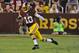 Washington Redskins quarterback Robert Griffin III (10) runs with the ball during the first half of an NFL preseason football game against the Cleveland Browns Monday, Aug. 18, 2014, in Landover, Md. (AP Photo/Richard Lipski)
