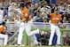 Miami Marlins' Giancarlo Stanton, left, rounds third base after hitting a three-run home run in the first inning during a baseball game against the Arizona Diamondbacks, Sunday, Aug.17, 2014, in Miami. At right is Miami Marlins third base coach Brett Butler. (AP Photo/Lynne Sladky)