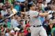 New York Yankees' Mark Teixeira follows through on a solo home run against the Boston Red Sox during the fifth inning of a baseball game at Fenway Park in Boston, Saturday, Aug. 2, 2014. (AP Photo/Winslow Townson)