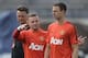 Manchester United's Wayne Rooney, left, talks with Jonny Evans as manager Louis van Gaal, left, watches during training for the their 2014 Guinness International Champions Cup soccer match against Real Madrid at Michigan Stadium in Ann Arbor, Mich., Friday, Aug. 1, 2014. (AP Photo/Paul Sancya)