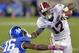 Alabama's Kenyan Drake, right, gets a hand in the face of Kentucky's Cody Quinn during the third quarter of an NCAA college football game, Saturday, Oct. 12, 2013, at Commonwealth Stadium in Lexington, Ky. Alabama defeated Kentucky 48-7. (AP Photo/Timothy D. Easley)