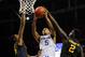 Mar 14, 2014; Atlanta, GA, USA; Kentucky Wildcats guard Andrew Harrison (5) goes to the basket between LSU Tigers forward Jordan Mickey (25) and forward Johnny O'Bryant III (2) during the second half in the quarterfinals of the SEC college basketball tournament at Georgia Dome. Kentucky defeated LSU 85-67. Mandatory Credit: Dale Zanine-USA TODAY Sports