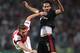Besiktas's Veli Kavlak, rear, and Aaron Ramsey of Arsenal fight for the ball during their Champions League play-off first leg soccer match in Istanbul, Turkey, Tuesday, Aug. 19, 2014. (AP Photo)