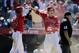 Los Angeles Angels' Mike Trout, right, and Josh Hamilton celebrate after Trout scored on a double hit by Albert Pujols during the ninth inning of a baseball game against the Seattle Mariners on Sunday, July 20, 2014, in Anaheim, Calif. The Angels won 6-5. (AP Photo/Jae C. Hong)