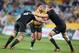 Australia's Nathan Charles, center, charges through the defense of New Zealand's Kieran Read, left, and Brodie Retallic during their Bledisloe Cup rugby union test match in Sydney, Saturday, Aug. 16, 2014. The game is a 12-all draw. (AP Photo/Rick Rycroft)