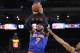Carmelo Anthony shoots over the outstretched arm of Andre Iguodala during a March 30 win in Oakland.
