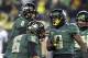 Oregon running back Byron Marshall, right, celebrates his touchdown with teammates Daryle Hawkins (16) and quarterback Marcus Mariota (8) during the second half of an NCAA college football game against UCLA in Eugene, Ore., Saturday, Oct. 26, 2013. Marshall ran for 133 yards and three touchdowns for a 42-14 victory. (AP Photo/Don Ryan)