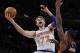 New York Knicks' Andrea Bargnani (77), of Italy, shoots over Toronto Raptors' Amir Johnson (15) as Kyle Lowry (7) watches during the first half of an NBA basketball game Friday, Dec. 27, 2013, in New York. (AP Photo/Frank Franklin II)