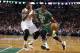 Boston Celtics guard Rajon Rondo (9) drives on Phoenix Suns' Eric Bledsoe during the first quarter of an NBA basketball game in Boston on Friday, March 14, 2014. (AP Photo/Winslow Townson)