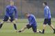 Arsenal's German players Per Mertesacker, left, Lukas Podolski, centre, and Mesut Ozil stretch during a training session at their London Colney training ground, Monday, March 10, 2014. Arsenal will play in a Champions League last sixteen second leg soccer match against Munich in Germany on Tuesday. (AP Photo/Kirsty Wigglesworth)