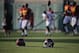 A pair of Southern California helmets sits on the field as players warm up during NCAA college football practice Wednesday, Aug. 20, 2014, in Los Angeles. (AP Photo/Jae C. Hong)