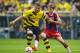 Dortmund's Ciro Immobile and Bayern's Gianluca Gaudino challenge for the ball with during the German soccer Super Cup match between Borussia Dortmund and Bayern Munich in Dortmund, Germany, Wednesday, Aug. 13, 2014. (AP Photo/Sascha Schuermann)