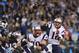 Nov 18, 2013; Charlotte, NC, USA; New England Patriots quarterback Tom Brady (12) throws a touchdown pass to tight end Rob Gronkowski (87) (not pictured) as guard Logan Mankins (70) blocks and Carolina Panthers defensive tackle Kawann Short (99) defends in the third quarter. The Panthers defeated the Patriots 24-20 at Bank of America Stadium. Mandatory Credit: Bob Donnan-USA TODAY Sports