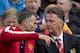 Manchester United's manager Louis van Gaal, right, takes his seat alongside assistant coach Ryan Giggs before the team's English Premier League soccer match against Swansea City at Old Trafford Stadium, Manchester, England, Saturday Aug. 16, 2014. (AP Photo/Jon Super)