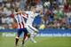 Real Madrid's Toni Kroos, right, fights for the ball with Atletico Madrid's Antoine Griezmann from France during a Spanish Super Cup soccer match at Santiago Bernabeu stadium in Madrid, Spain, Tuesday, Aug. 19, 2014 . (AP Photo/Daniel Ochoa de Olza)
