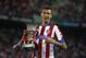 Atletico' Mandzukic celebrates the victory with the Trophy during a Spanish Supercup second leg soccer match between Real Madrid and Atletico Madrid at Vicente Calderon stadium in Madrid, Spain, Saturday, Aug. 23, 2014. (AP Photo/Andres Kudacki)