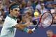 Roger Federer, from Switzerland, returns a volley to Milos Raonic, from Canada, during a semifinal at the Western & Southern Open tennis tournament, Saturday, Aug. 16, 2014, in Mason, Ohio. Federer won 6-2, 6-3. (AP Photo/David Kohl)