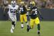 Green Bay Packers running back DuJuan Harris (26) rushes for a gain as Oakland Raiders outside linebacker Khalil Mack (52) chases him during the first half of an NFL preseason football game Friday, Aug. 22, 2014, in Green Bay, Wis. (AP Photo/Tom Lynn)