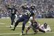 Seattle Seahawks' Marshawn Lynch (24) scores as quarterback Russell Wilson (3) reacts behind and Chicago Bears' Danny McCray hits the turf in the first half of an preseason NFL football game, Friday, Aug. 22, 2014, in Seattle. (AP Photo/Stephen Brashear)