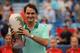 CINCINNATI, OH - AUGUST 17: Roger Federer of Switzerland poses with the winner's trophy after a final match against David Ferrer of Spain on day 9 of the Western & Southern Open at the Linder Family Tennis Center on August 17, 2014 in Cincinnati, Ohio. (Photo by Jonathan Moore/Getty Images)