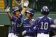 South Korea's Jae Yeong Hwang, left, celebrates with teammates Dong Hwan Ahn, center, and Ji Ho Park (10) after all three scored on an RBI double by Dong Wan Sin in the second inning against Japan in the International Championship baseball game at the Little League World Series tournament in South Williamsport, Pa., Saturday, Aug. 23, 2014. (AP Photo/Gene J. Puskar)