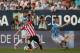 MALAGA, SPAIN - AUGUST 23: Muniain (C) of Athletic Club Bilbao controls the ball against Samuel (L) and Ignacio Camacho (R) of Malaga CF during the La Liga match between Malaga CF and Athletic Club Bilbao at La Rosaleda Stadium on August 23, 2014 in Malaga, Spain. (Photo by Sergio Camacho/Getty Images)