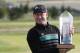 Jamie Donaldson from Wales poses with the trophy after winning the golf Czech Masters European Tour Event in Vysoky Ujezd, Czech Republic, Sunday, Aug. 24, 2014. (AP Photo/Petr David Josek)