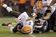 Cleveland Browns quarterback Johnny Manziel (2) is sacked by St. Louis Rams defensive end Michael Sam (96) in the fourth quarter of a preseason NFL football game Saturday, Aug. 23, 2014, in Cleveland. (AP Photo/Tony Dejak)