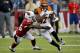 Cincinnati Bengals wide receiver Mohamed Sanu (12) runs after the catch as Arizona Cardinals cornerback Jerraud Powers (25) defends during the first half of an NFL preseason football game, Sunday, Aug. 24, 2014, in Glendale, Ariz. (AP Photo/Rick Scuteri)
