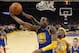 Golden State Warriors forward Andre Iguodala, left, puts up a shot as Los Angeles Lakers center Jordan Hill defends during the first half of an NBA basketball game, Friday, Nov. 22, 2013, in Los Angeles. (AP Photo/Mark J. Terrill)