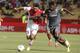 Monaco's Emmanuel Riviere of France, left, challenges for the ball with Lorient's Bruno Ecuele Manga of Gabon during their French League One soccer match, in Monaco stadium, Sunday, Sept. 15, 2013. (AP Photo/Lionel Cironneau)