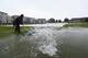BRISTOL, ENGLAND - AUGUST 25: Groundstaff sweep away puddles from the outfield in vain as play is abandoned in the first Royal London One-Day Series match between England and India at The County Ground on August 25, 2014 in Bristol, England. (Photo by Michael Steele/Getty Images)