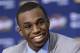 FILE - In this June 27, 2014, file photo, Cleveland Cavaliers draft pick Andrew Wiggins smiles during an NBA basketball conference in Independence, Ohio. Two people with knowledge of the deal tell The Associated Press that Minnesota and Cleveland have agreed to a trade that will send All-Star forward Kevin Love to the Cavaliers for Wiggins, Anthony Bennett and a future first-round draft pick. The two people spoke Thursday, Aug. 7, 2014, on condition of anonymity because no official agreement can be reached until Aug. 23, when Wiggins, this year's No. 1 draft pick, becomes eligible to be traded. (AP Photo/Tony Dejak, File)