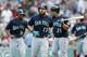 Seattle Mariners' Dustin Ackley (13) heads to the dug out after hitting a three-run home run during the fourth inning of a baseball game against the Boston Red Sox in Boston, Saturday, Aug. 23, 2014. (AP Photo/Michael Dwyer)