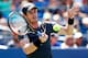 NEW YORK, NY - AUGUST 25: Andy Murray of Great Britain returns a shot against Robin Haase of the Netherlands during his men's singles first round match on Day One of the 2014 US Open at the USTA Billie Jean King National Tennis Center on August 25, 2014 in the Flushing neighborhood of the Queens borough of New York City. (Photo by Julian Finney/Getty Images)