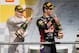 Red Bull driver Daniel Ricciardo of Australia, right, and Williams driver Valtteri Bottas of Finland spray champagne as they stand on the podium after the Belgian Formula One Grand Prix in Spa-Francorchamps, Belgium, Sunday, Aug. 24, 2014. Red Bull driver Daniel Ricciardo of Australia won the race, Mercedes driver Nico Rosberg of Germany finished second and Williams driver Valtteri Bottas of Finland third. (AP Photo/Geert Vanden Wijngaert)