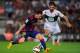 BARCELONA, SPAIN - AUGUST 24: Lionel Messi of FC Barcelona takes on Sergio Pelegrin of Elche FC during the La Liga match between FC Barcelona and Elche FC at Camp Nou stadium on August 24, 2014 in Barcelona, Spain. (Photo by Denis Doyle/Getty Images)