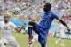 Italy's Mario Balotelli kicks the ball over Uruguay's Martin Caceres during the group D World Cup soccer match between Italy and Uruguay at the Arena das Dunas in Natal, Brazil, Tuesday, June 24, 2014. (AP Photo/Ricardo Mazalan)