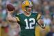GREEN BAY, WI - AUGUST 22: Quarterback Aaron Rodgers #12 of the Green Bay Packers looks to pass during the first quarter of a preseason game against the Oakland Raiders at Lambeau Field on August 22, 2014 in Green Bay, Wisconsin. The Packers defeated the Raiders 31-21. (Photo by Jonathan Daniel/Getty Images)