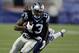New England Patriots cornerback Darrelle Revis, rear, tries to wrap up Carolina Panthers wide receiver Kelvin Benjamin (13) in the first half of an NFL preseason football game Friday, Aug. 22, 2014, in Foxborough, Mass. (AP Photo/Charles Krupa)