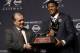 Florida State quarterback Jameis Winston, right, stands with FSU coach Jimbo Fisher while holding the Heisman Trophy after winning the award on Saturday, Dec. 14, 2013, in New York. (AP Photo/Julio Cortez)