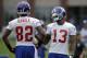 New York Giants wide receiver Odell Beckham, right, talks with wide receiver Rueben Randle during a NFL football camp in East Rutherford, N.J., Thursday, July 24, 2014. (AP Photo/Seth Wenig)