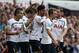 Tottenham Hotspur's Nacer Chadli, center, celebrates his goal against Queens Park Rangers with teammates during their English Premier League soccer match at White Hart Lane, London, Sunday, Aug. 24, 2014. (AP Photo/Sang Tan)