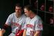 Cincinnati Reds' Joey Votto, left, and teammate Jay Bruce (32), sit on the bat rack before a baseball game against the Pittsburgh Pirates in Pittsburgh Thursday, June 19, 2014. The Pirates won 4-3 in 12 innings. (AP Photo/Gene J. Puskar)