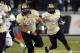 Central Florida running back William Stanback (28) follows the block of Joey Grant (55) during the first half of an NCAA college football game on Friday, Nov. 29, 2013, in Orlando, Fla. UCF won 23-20. (AP Photo/Reinhold Matay)