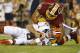 Cleveland Browns quarterback Brian Hoyer is sacked by Washington Redskins outside linebacker Ryan Kerrigan during the first half of an NFL preseason football game Monday, Aug. 18, 2014, in Landover, Md. (AP Photo/Evan Vucci)