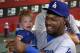PHOENIX, AZ - AUGUST 27: Hanley Ramirez #13 of the Los Angeles Dodgers holds a baby in the dugout before the MLB game against the Arizona Diamondbacks at Chase Field on August 27, 2014 in Phoenix, Arizona. (Photo by Christian Petersen/Getty Images)