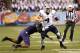 SAN FRANCISCO, CA - DECEMBER 27: Taysom Hill #4 of the BYU Cougars runs with the ball, breaking the tackle of Sean Parker #1 of the Washington Huskies during the second quarter in the Fight Hunger Bowl at AT&T Park on December 27, 2013 in San Francisco, California. (Photo by Thearon W. Henderson/Getty Images)